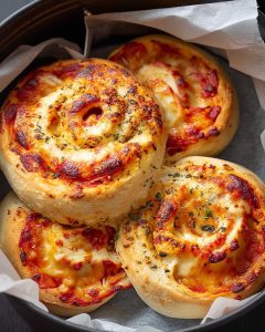 Pizza Rolls Air Fryer swirls with melted cheese, tomato sauce, and Italian herbs.