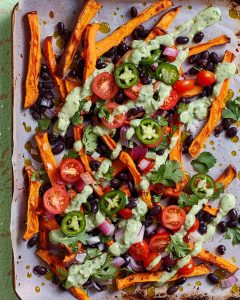 Loaded Sweet Potato Fries Air Fryer topped with black beans, cherry tomatoes, jalapeños, red onion, cilantro.